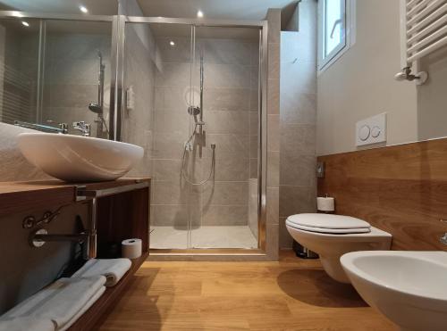 a bathroom with a shower and a toilet and a sink at Hotel Concord - Nel cuore di Riccione in Riccione