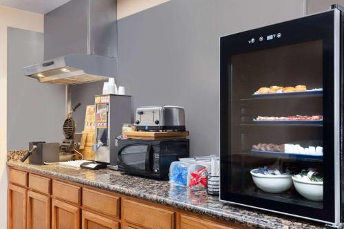 a kitchen with a counter with food on it at Howard Johnson by Wyndham Williams in Williams