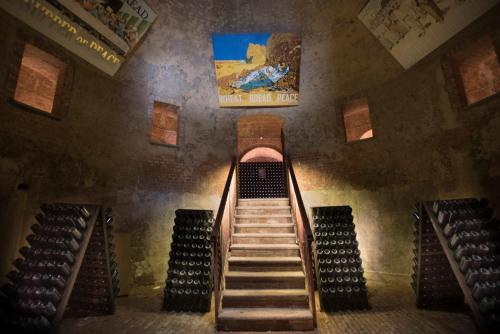 a staircase in a building with a painting on the wall at Villaggio Narrante - Le Case dei Conti Mirafiore in Serralunga d'Alba