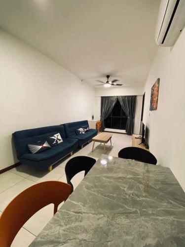 a living room with a table and a blue couch at K Avenue with Peak Escapes A708 in Donggongon