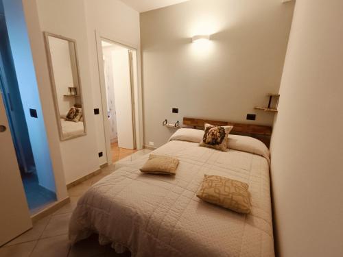 a bedroom with a bed with two pillows on it at CASA ORNETO in Poggibonsi