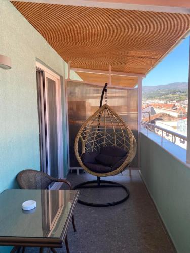 a room with a swing on a balcony at Le Bijou Luxury Rooms & Suites in Veria