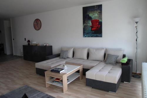 ein Wohnzimmer mit einem Sofa und einem Tisch in der Unterkunft Wohnung in Lützelsachsen in Weinheim