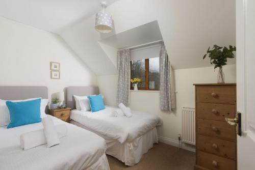 a bedroom with two beds and a window at Godolphin in Wadebridge