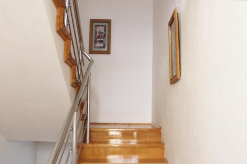 a staircase in a house with two pictures on the wall at Farah Apartment in Mostar