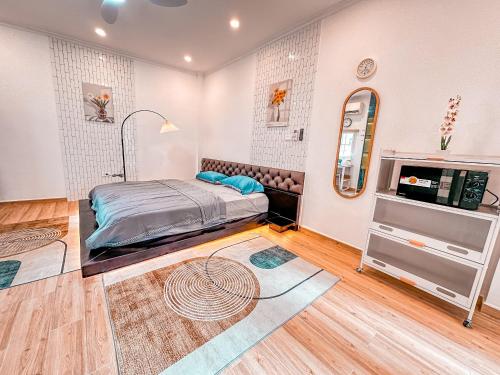 a bedroom with a bed and a mirror at La Casa Di Dicembre in Hanoi