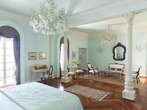 a bedroom with a bed and a chandelier at La Maison Bleue El Gouna in Hurghada
