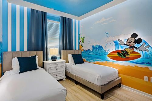 a bedroom with two beds and a mickey mouse mural at 3141 Paradox Circle 406 in Kissimmee