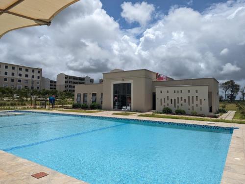 a large swimming pool in front of a building at Viwak Homes in Mombasa