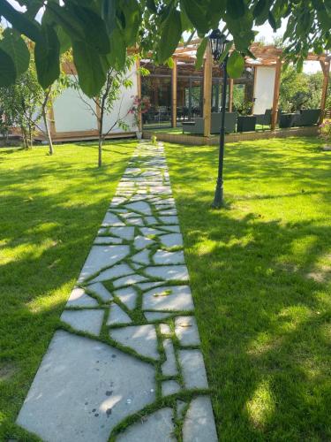a stone path in a park with grass at Agropa Rooms & Garden Events in Bistriţa