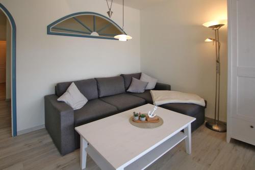 a living room with a couch and a table at Gro_e Stra_e 19_ Whg_ 1 in Wyk auf Föhr