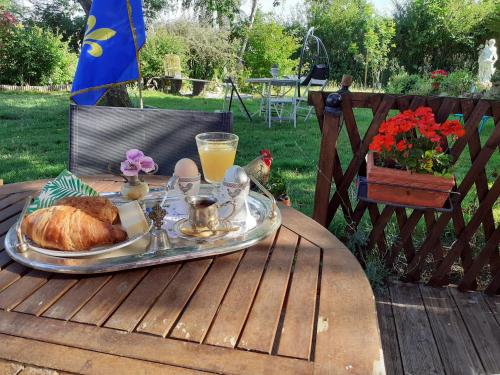 a tray of food on a table with a turkey and orange juice at LE VIEIL HERMITAGE in Ervauville