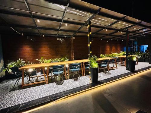 a patio with a table and chairs and plants at Gallivanto Inn in New Delhi