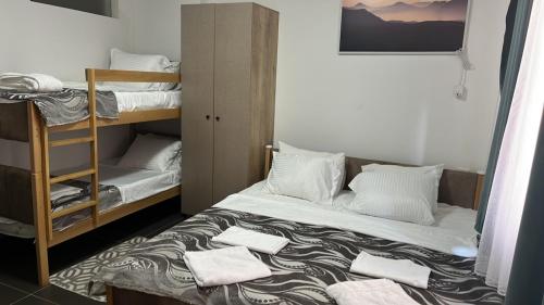 a room with two bunk beds with towels on the floor at Hotel City Rooms Prishtina in Pristina