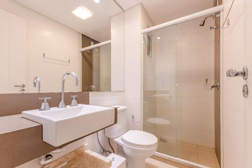 a bathroom with a sink and a toilet and a shower at Boulevard Bombinhas - Lindíssimo Apartamento em Condo com Piscina e Jacuzzi in Bombinhas