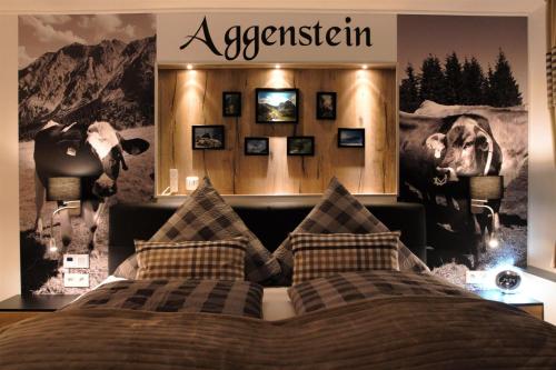 a bedroom with a bed with a poster of cows at Ferienwohnungen Wolf- Studio Zimmer mit Bergblick in Pfronten