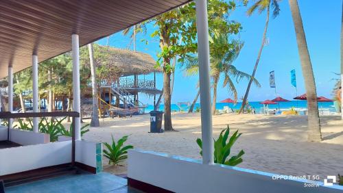 a view of a beach with a resort and the ocean at French garden Pragash Beach Hotel in Trincomalee