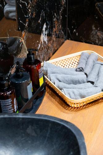 a wooden table with a towel and two bottles of soap at AuraLux in Agia Triada