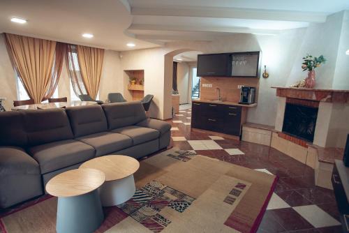 a living room with a couch and a fireplace at Apart4you Hotel in Chişinău