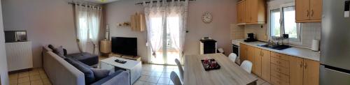 a kitchen and living room with a table and chairs at Nina Apartment in Chania Town