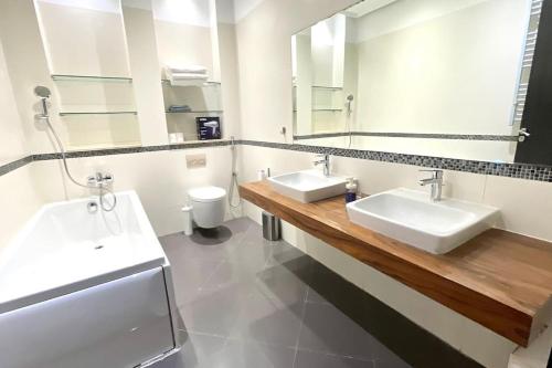 a bathroom with two sinks and a mirror at Luxury villa with private pool in Casablanca