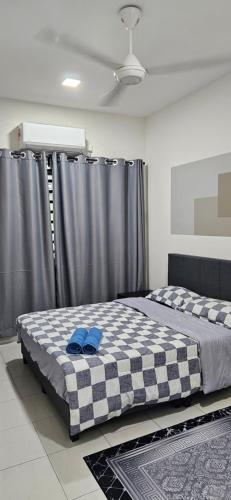 a bedroom with a bed with a checkered blanket at TELUK INTAN LANDED LUXURY HOMESTAY 3BEDROOM in Teluk Intan