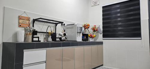 a kitchen with a counter with a coffee maker on it at TELUK INTAN LANDED LUXURY HOMESTAY 3BEDROOM in Teluk Intan