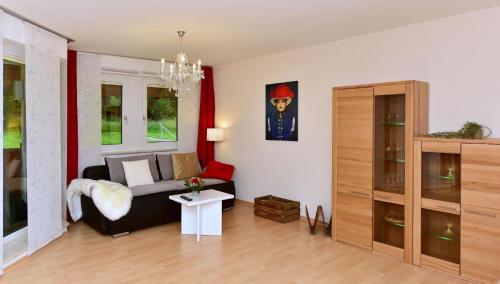 a living room with a couch and a table at Appartement in Saig mit Garten und Grill in Lenzkirch