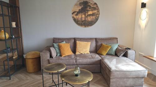 a living room with a couch and two tables at Haus Blick am Edersee 4P in Waldeck
