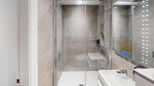 a bathroom with a shower and a sink at MSK Elite in London
