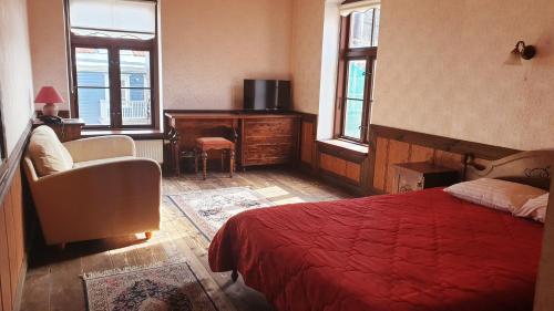 a bedroom with a red bed and a desk at St. Peterburg in Pärnu