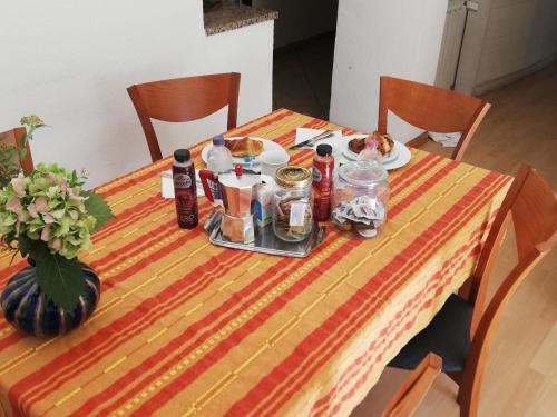 una mesa con un plato de comida y botellas en ella en Ferienwohnung für 4 Personen ca 90 qm in Duino-Aurisina, Adriaküste Italien Küste von Friaul-Julisch Venetien, en Duino