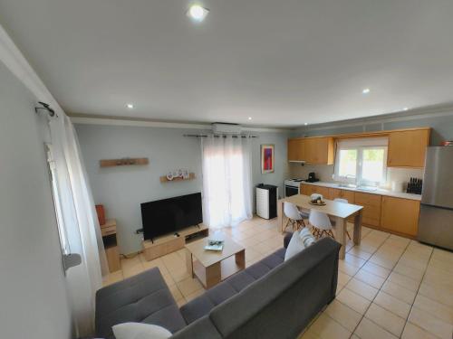 a living room with a couch and a table and a kitchen at Nina Apartment in Chania Town