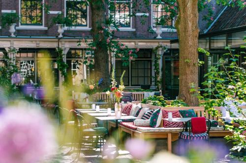 a group of tables and chairs in a garden at Relais & Châteaux Weeshuis Gouda in Gouda