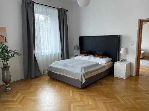 a bedroom with a bed and a large window at Studios Klagenfurt in Klagenfurt