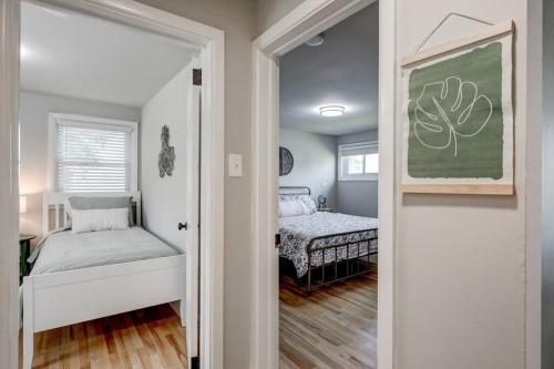 a bedroom with two beds and a door leading into a room at Renovated 2 BR home close to Lancaster attractions in Lancaster