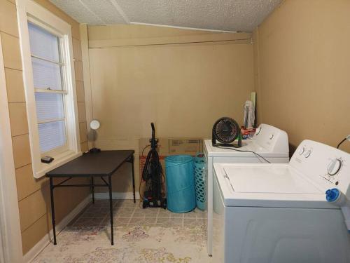 a laundry room with a sink and a washing machine at Quiet Country Small Family Home 5 minutes from town in Mansura