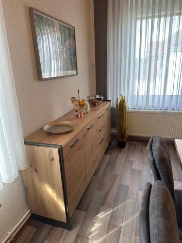 a kitchen with a wooden dresser in a room at Auguststadt-Residenz in Wolfenbüttel