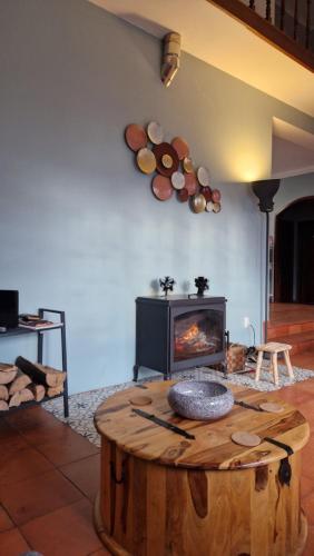 a living room with a wooden table and a fireplace at Beachwalk guesthouse in Esmoriz