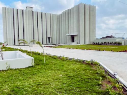 a large white building with a lawn in front of it at VITS Jamnagar in Jamnagar