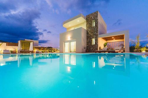 a large swimming pool in front of a house at Cleopatra's Villa Luxury Retreat South Rhodes in Lachania