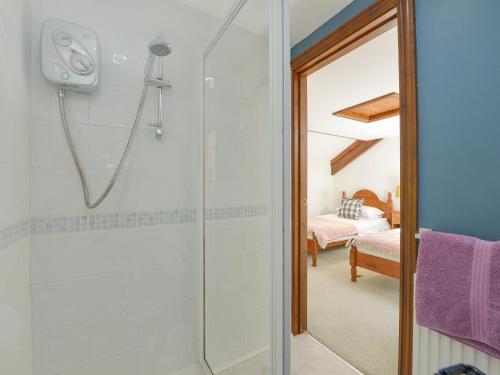 a bathroom with a shower and a bedroom at Valley View in Barnstaple