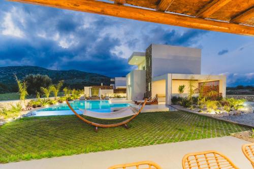 a villa with a hammock and a swimming pool at Cleopatra's Villa Luxury Retreat South Rhodes in Lachania