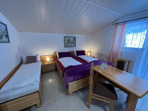 um quarto com 2 camas, uma secretária e uma mesa em Club Villa em Ramsau am Dachstein