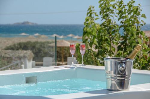 a hot tub with two glasses of wine at Golden Sand in Plaka