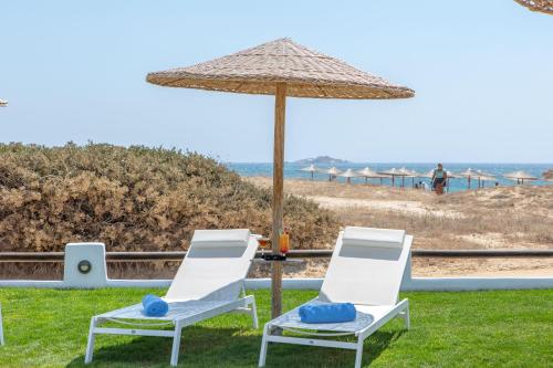 two chairs and an umbrella on the beach at Golden Sand in Plaka