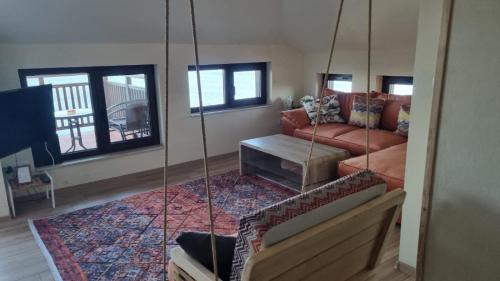 a living room with a couch and a swing at Villa Elea in Nesebar