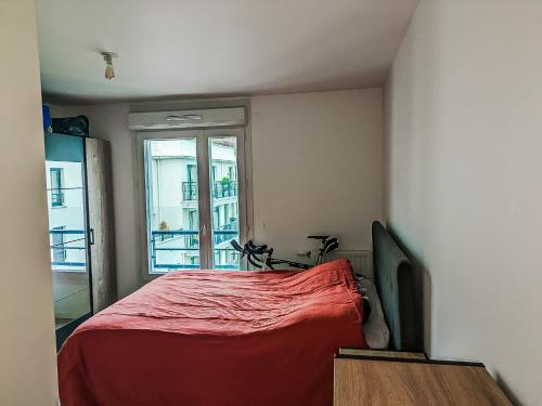 1 dormitorio con cama roja y ventana en HbyB- 3BR -Face Bois de boulogne, en Suresnes