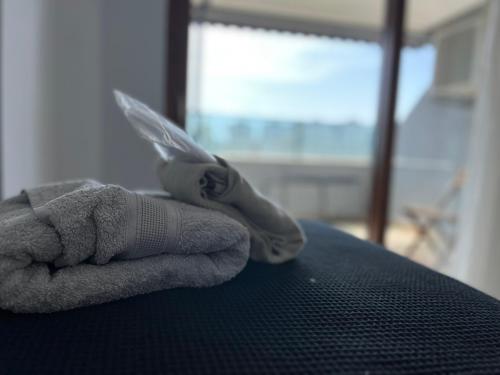 a person holding a towel on a bed with a cell phone at Gardenya Lara Suit Hotel in Antalya