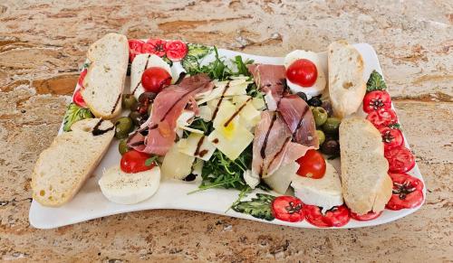 a plate of food with a salad and bread at Höckner Plaza Hotel in Attnang-Puchheim